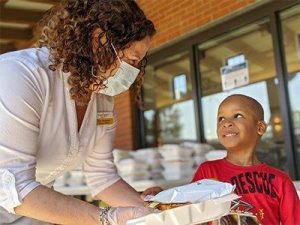 Volunteer speaks to child